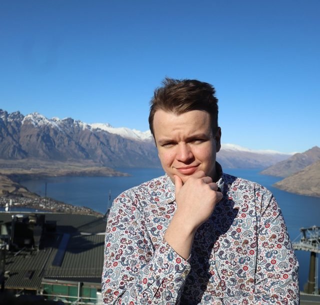 Jáchym in front of a lake and mountains